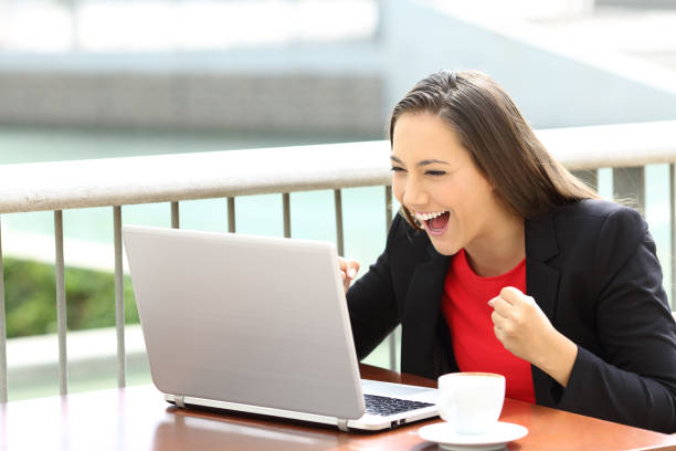 istock Excited executive reading notification in a laptop 837350274
