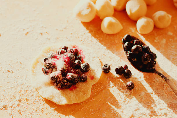istock Sweet dumplings with blackberry - process of making. Top view, closeup 837351398