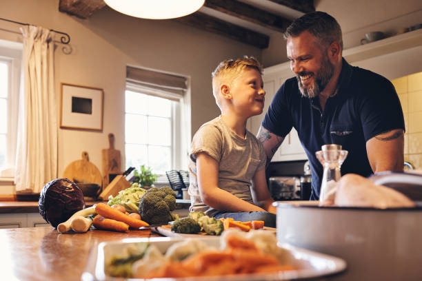 istock Father and son smiling in the kitchen 837354394
