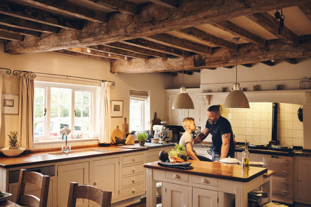 istock Father and son talking and smiling in kitchen 837354460