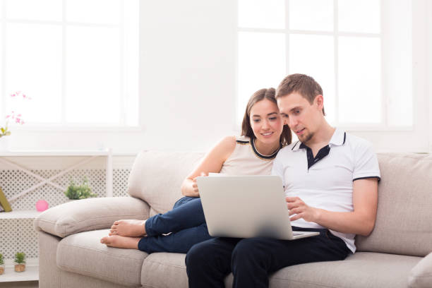 istock Young couple web surfing on laptop, copy space 837357848