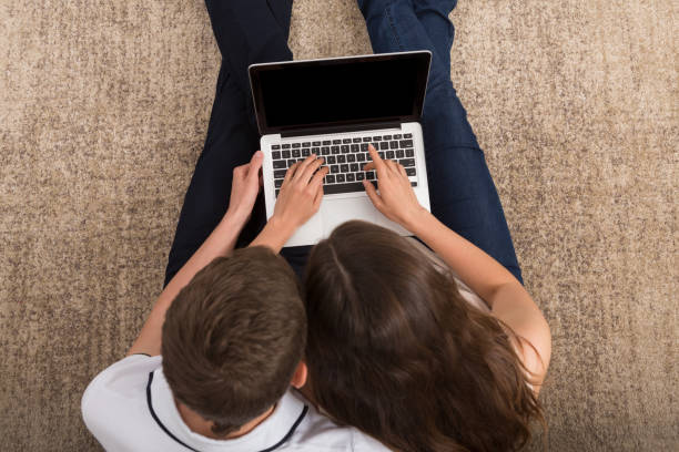 istock Young couple web surfing on laptop, copy space 837358106