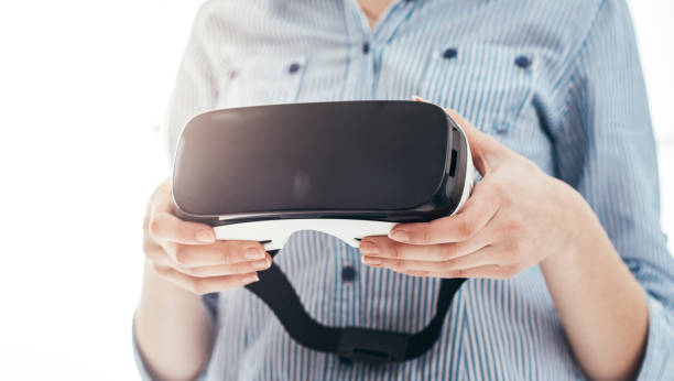 istock Woman holding a VR headset 837359102