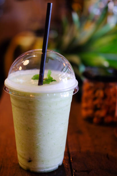 istock Pineapple with mint smoothie on wooden table 837369348