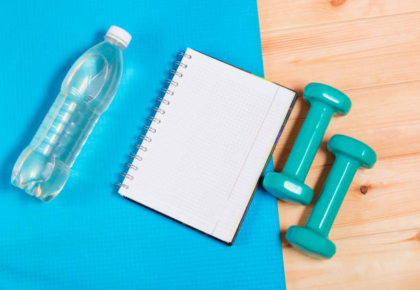 istock Bottle of  water, notebook and  dumbbells 837385746