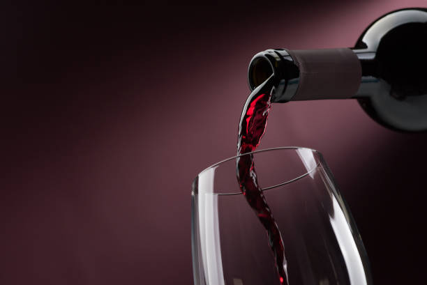 istock Pouring red wine into a wineglass 837385810