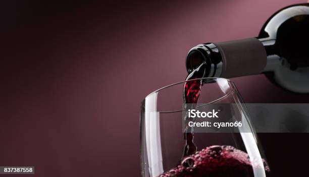 Pouring Red Wine Into A Wineglass Stock Photo - Download Image Now - Wine, Red Wine, Wine Bottle