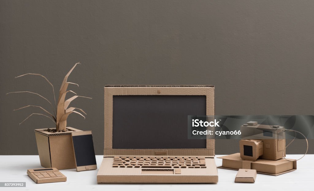 Eco-friendly creative cardboard office Eco-friendly creative office items and laptop made from recycled cardboard, crafts and ecology concept Cardboard Stock Photo