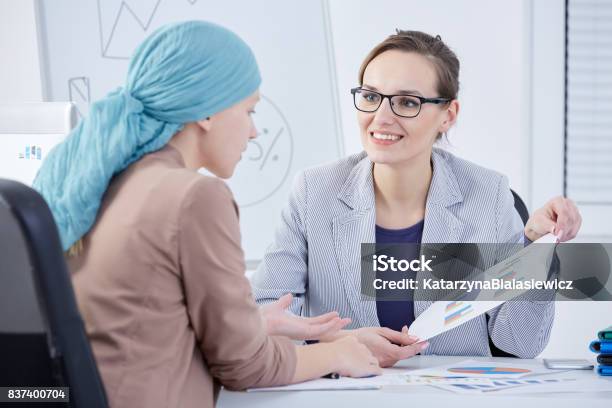 Doctor Showing A Chart To A Patient Stock Photo - Download Image Now - Oncology, Cancer - Illness, Doctor