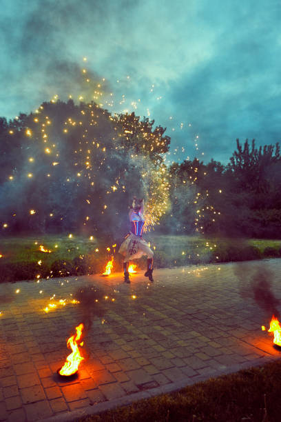 istock Dancing with fire in the dark on the street. 837401188