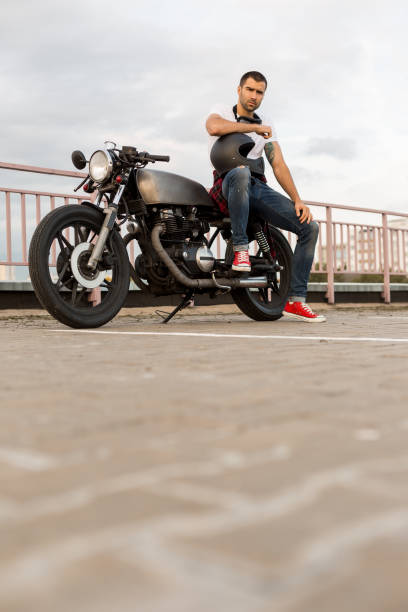 istock Brutal man sit on cafe racer custom motorbike. 837402408