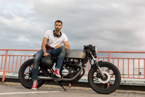 istock Brutal man sit on cafe racer custom motorbike. 837402772