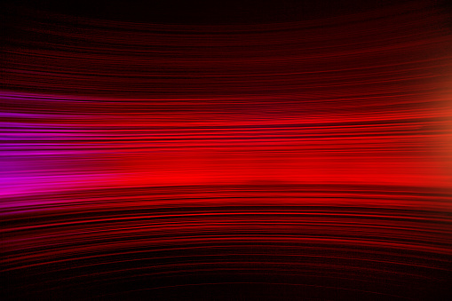 shot of red neon or fibre optic light with a motion blur feel and a dark background. ideal for use as an abstract background with copy space for the designer. All effect are natural and achieved photographically not with post production effects.