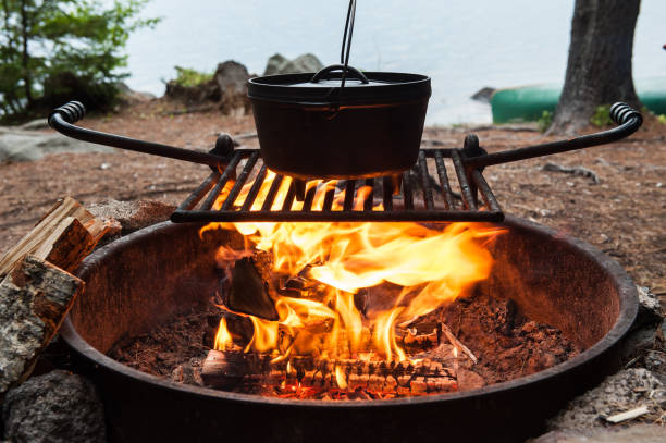 Dutch oven cooking over a campfire stock photo