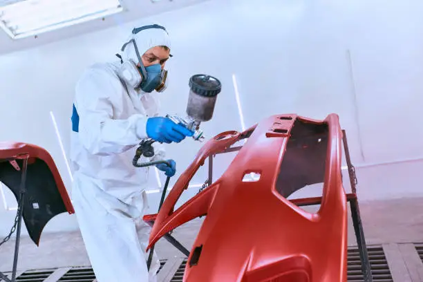 Photo of Painting the car's bumper red on the service.