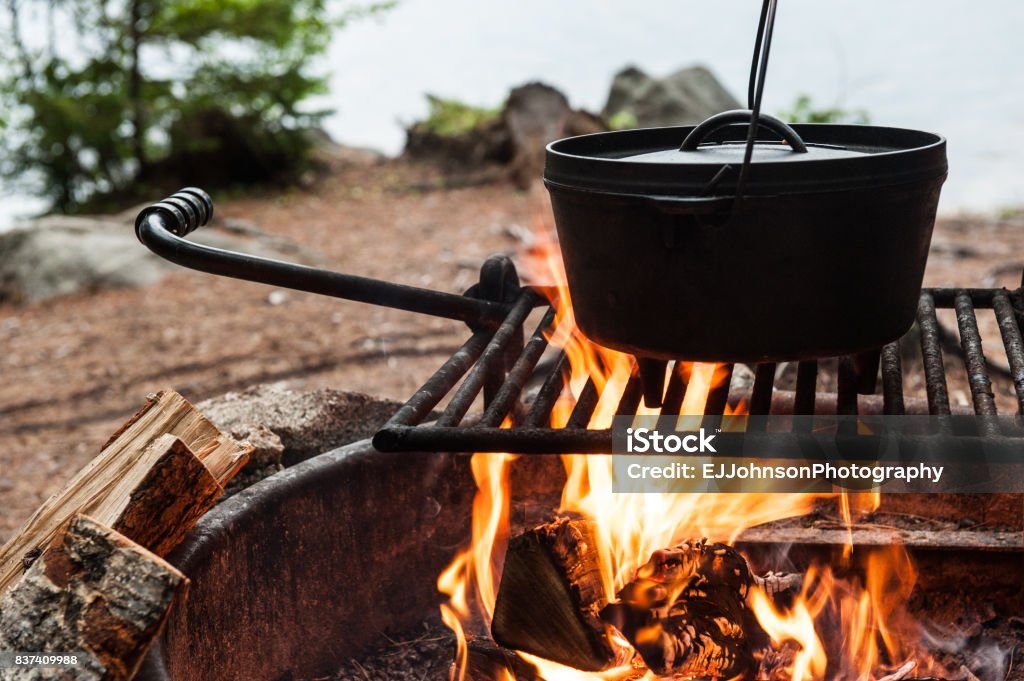 Dutch oven cooking over a campfire Cooking Stock Photo