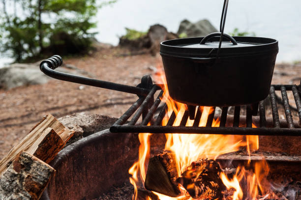Dutch oven cooking over a campfire stock photo