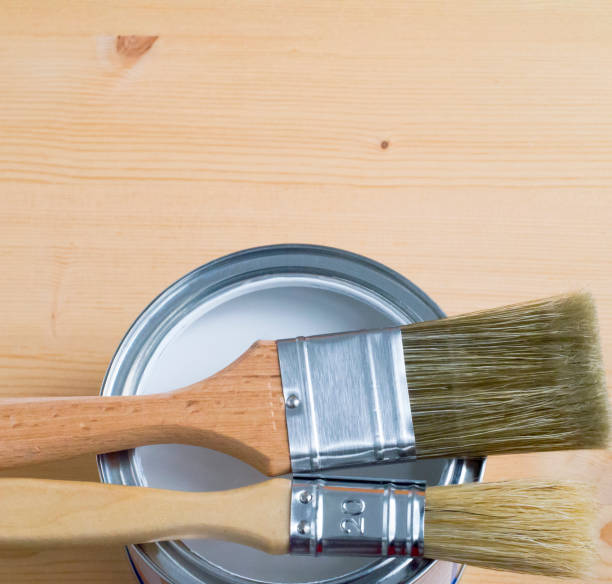 istock paint brush on metall can over wooden background 837418702