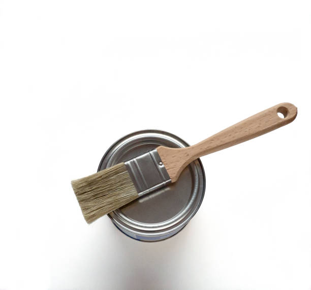 istock White paint with paint brush on metall can over white background 837418860