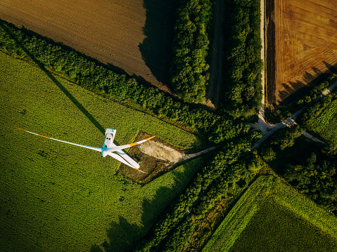 Aerial view of a wind turbine and cultivated fields