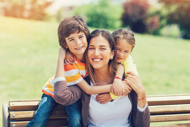 istock Happy mother holding two children 837421964