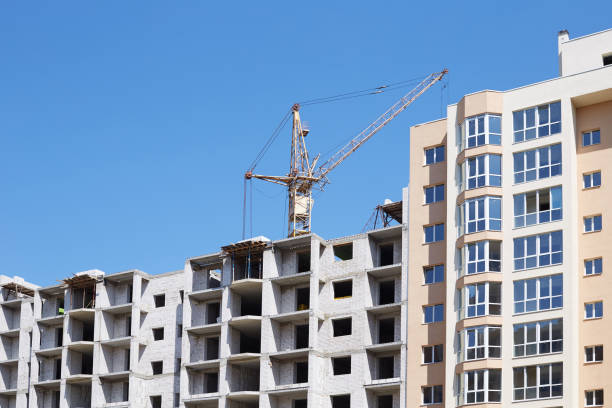 istock Crane and building construction site against blue sky 837423044