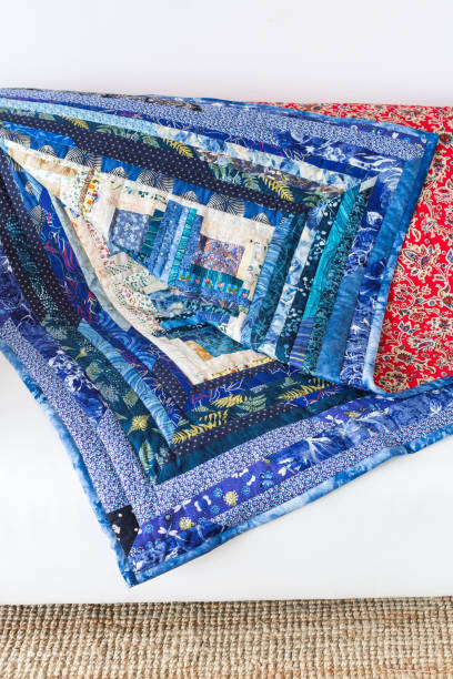 istock creation, garment industry, tradition, needlework, geometric, coloring, interior cocnept - colorful blanket composed of blue colored textile patches and bright scarlet fabric on the other side 837439334