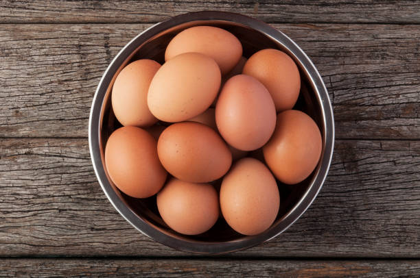 istock Eggs in bowl on wooden table background. 837444940