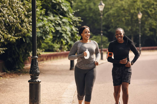 istock Female friends running in the park 837453262