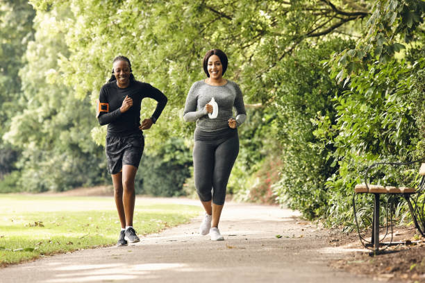 istock Two women running in the park 837453688