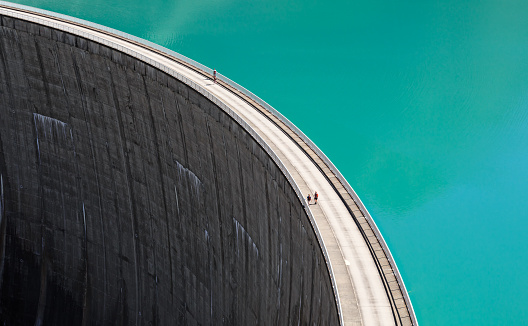 People walking on edge of Stausee Mooserboden Dam, Kaprun, Austria