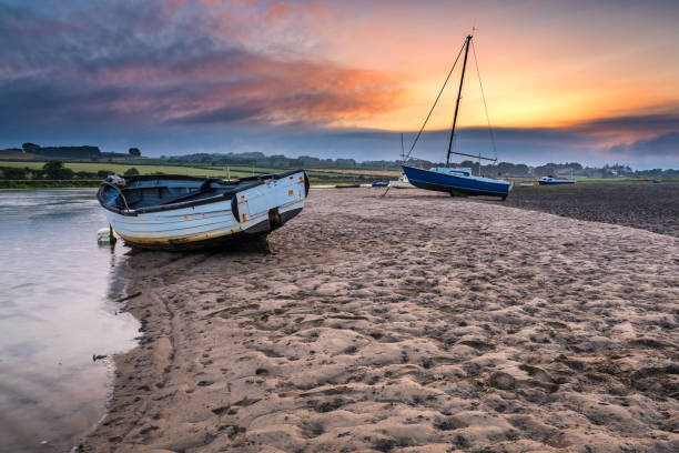 Boats on the Aln Estuary at Sunset stock photo