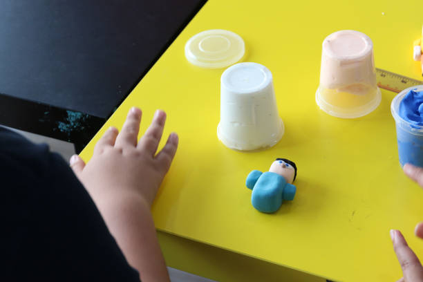 istock sculpted blue human play dough on yellow table 837473238