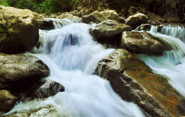 istock River cascading through the rocky river bed 837474350