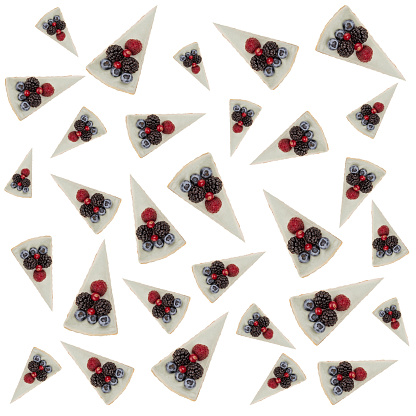 Pattern of blue cheesecakes with different tasty berries isolated