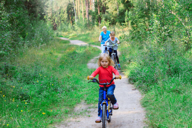 istock active senior with grandkids riding bikes in nature 837486350