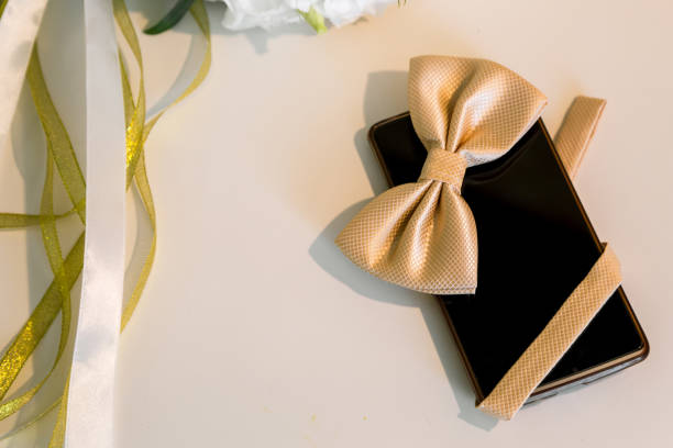 istock Accessories groom's wedding day. Mobile phone and butterfly 837487740