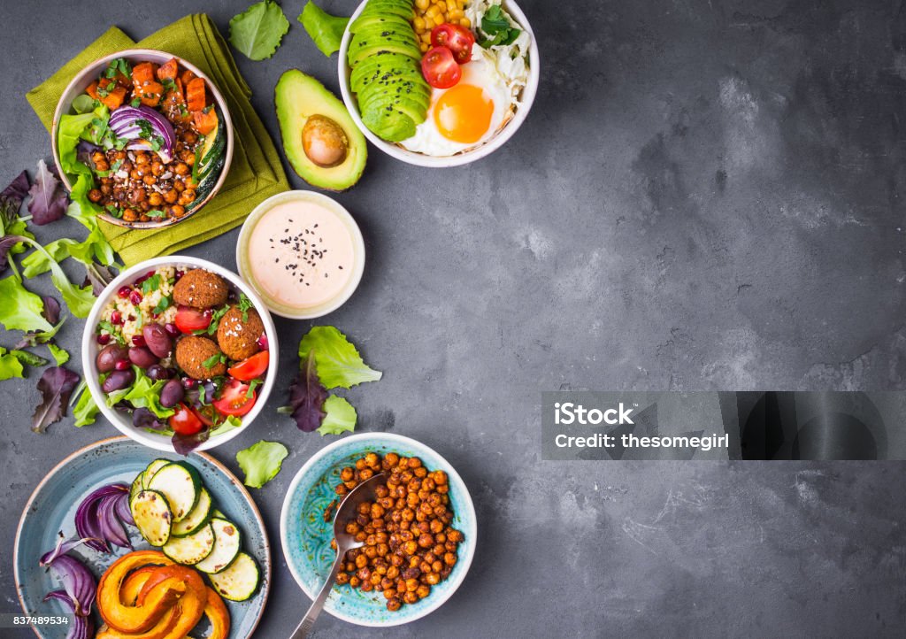 Buddha bowl salads background Mixed healthy vegetarian salads with vegetables, sweet potato, falafel, bulgur, avocado, eggs. Assorted buddha bowl salads background. Healthy dinner. Salad in bowl. Making ingredients. Space for text Appetizer Stock Photo