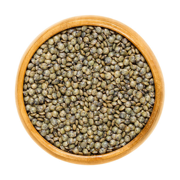 puy lentils in wooden bowl over white - green lentil imagens e fotografias de stock