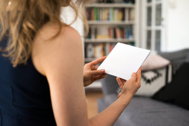 istock Young woman looking at a blank brouchure page with copy space 837505548