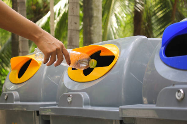 istock Woman hand holding throwing bottle water into the recycle bin 837507324