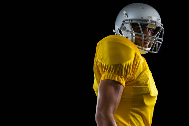 istock American football player standing against a black background 837512564