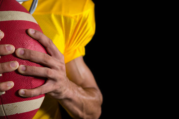 istock American football player holding a ball with both his hands 837512830