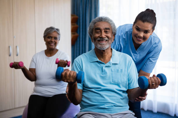 istock Nurse training seniors in lifting dumbbells at nursing home 837514190