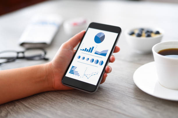 analyse von finanz-charts auf smartphone - mobiles gerät grafiken stock-fotos und bilder