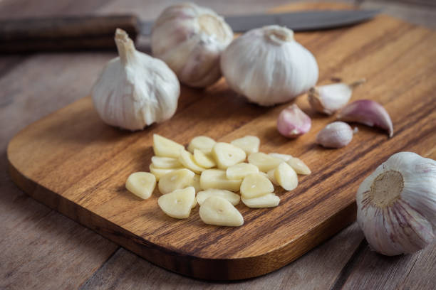 istock Garlic on wooden cutting board 837538970