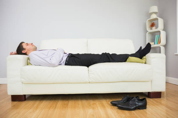 istock Tired businessman sleeping on sofa in living room 837549172