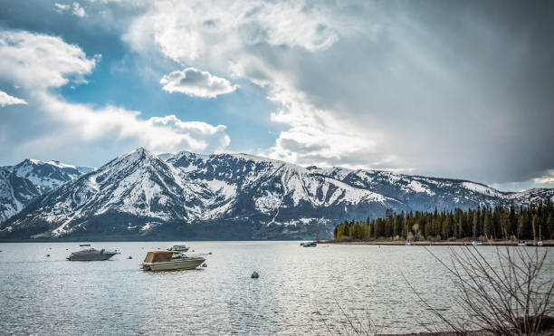 istock Grand Tetons in spring are still covered in snow as boaters explore Jackson Lake on a crystal clear day 837549320
