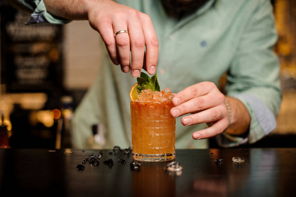 istock Bartender decorates a summerr cocktail no face 837553452