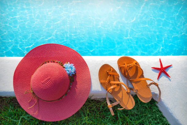 istock hat and shoes by the pool 837562438